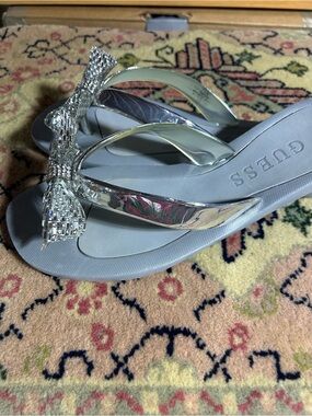 GUESS Silver Rhinestone Bow Flip Flops